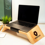 a laptop computer sitting on a wooden stand