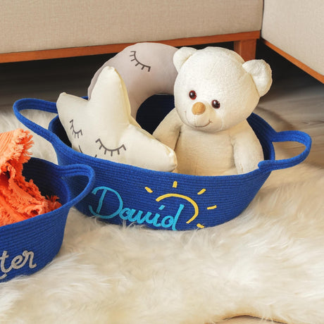 a teddy bear sitting in a basket next to other baskets