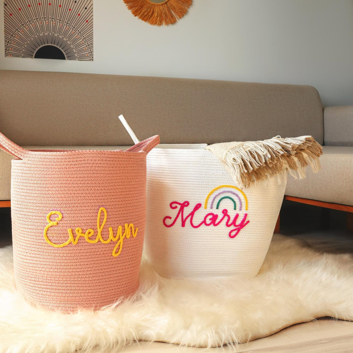 two personalized laundry baskets sitting on a fur rug