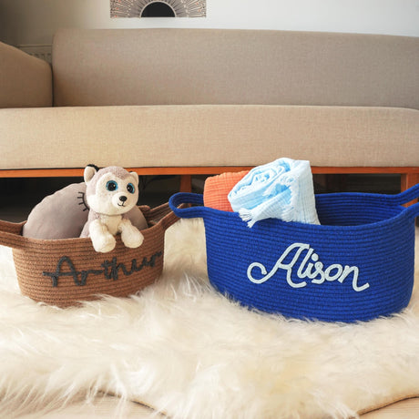 two baskets with stuffed animals in them sitting on a rug