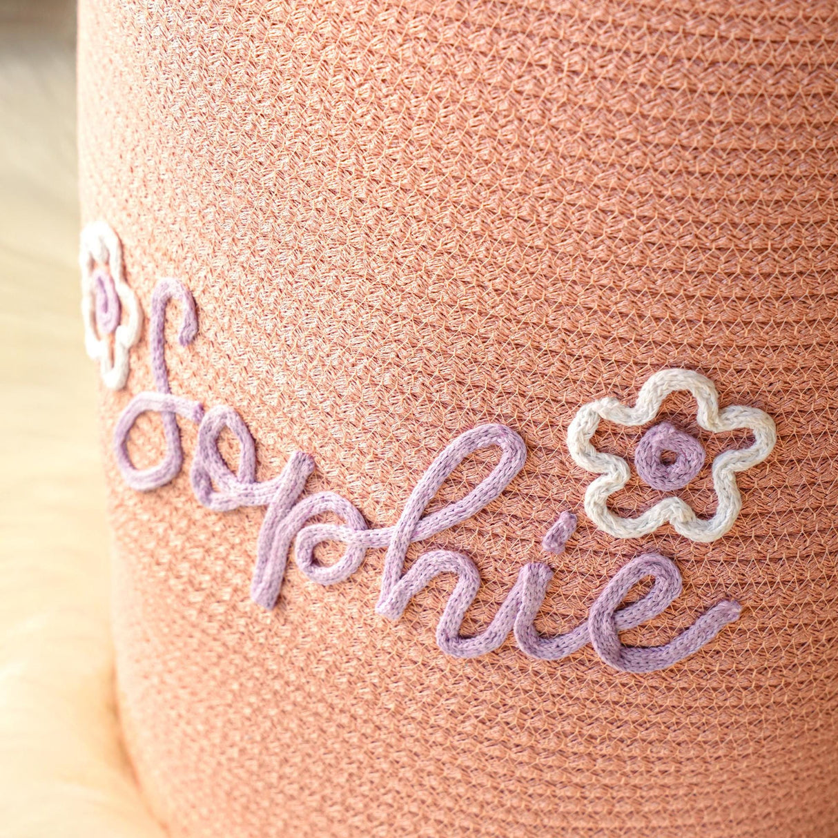 a close up of a crocheted pillow with a name on it