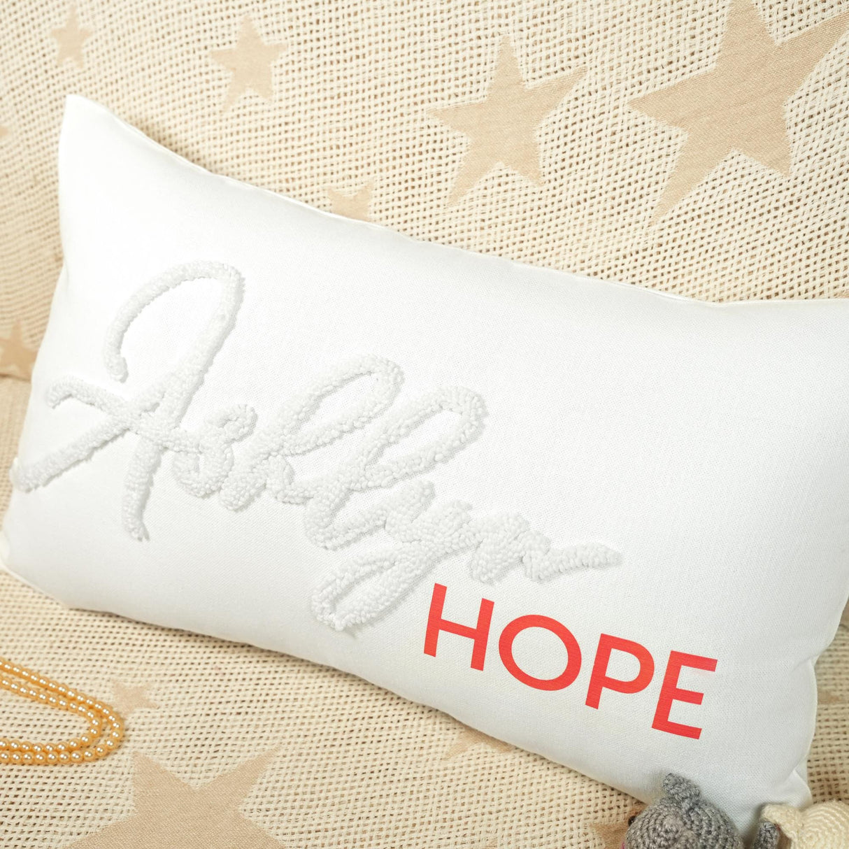 a white pillow with the word hope on it