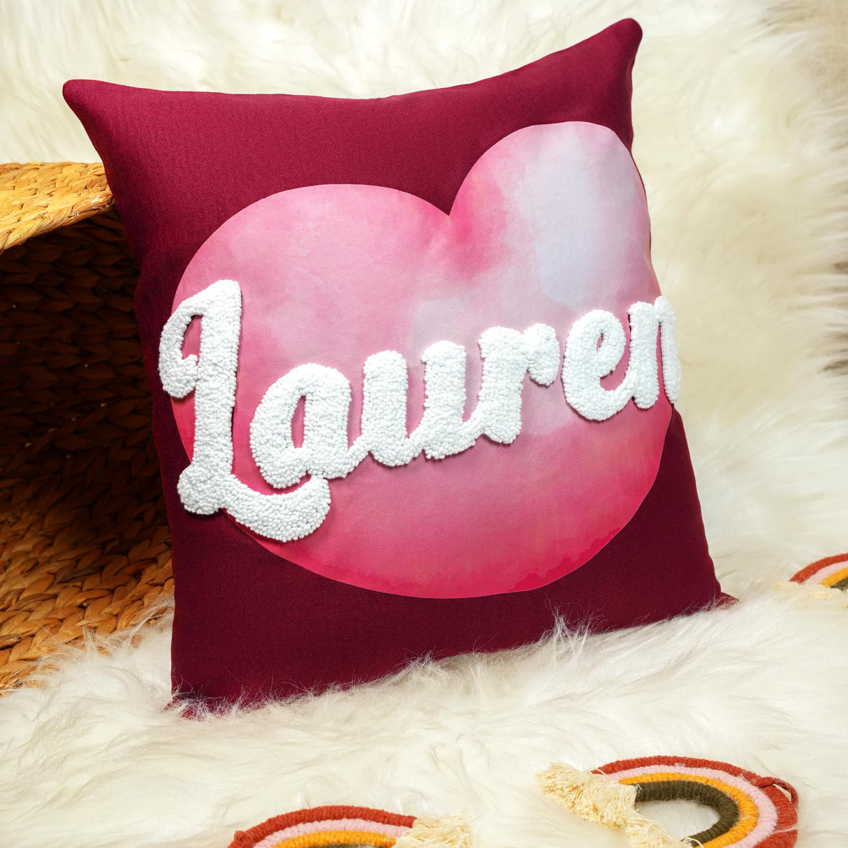 a heart shaped pillow with the word lauren on it