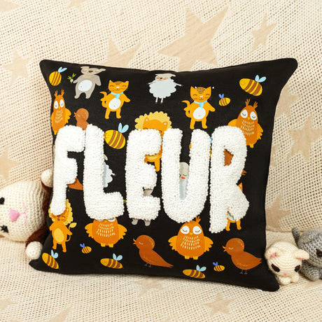 a black pillow with the word fleur on it