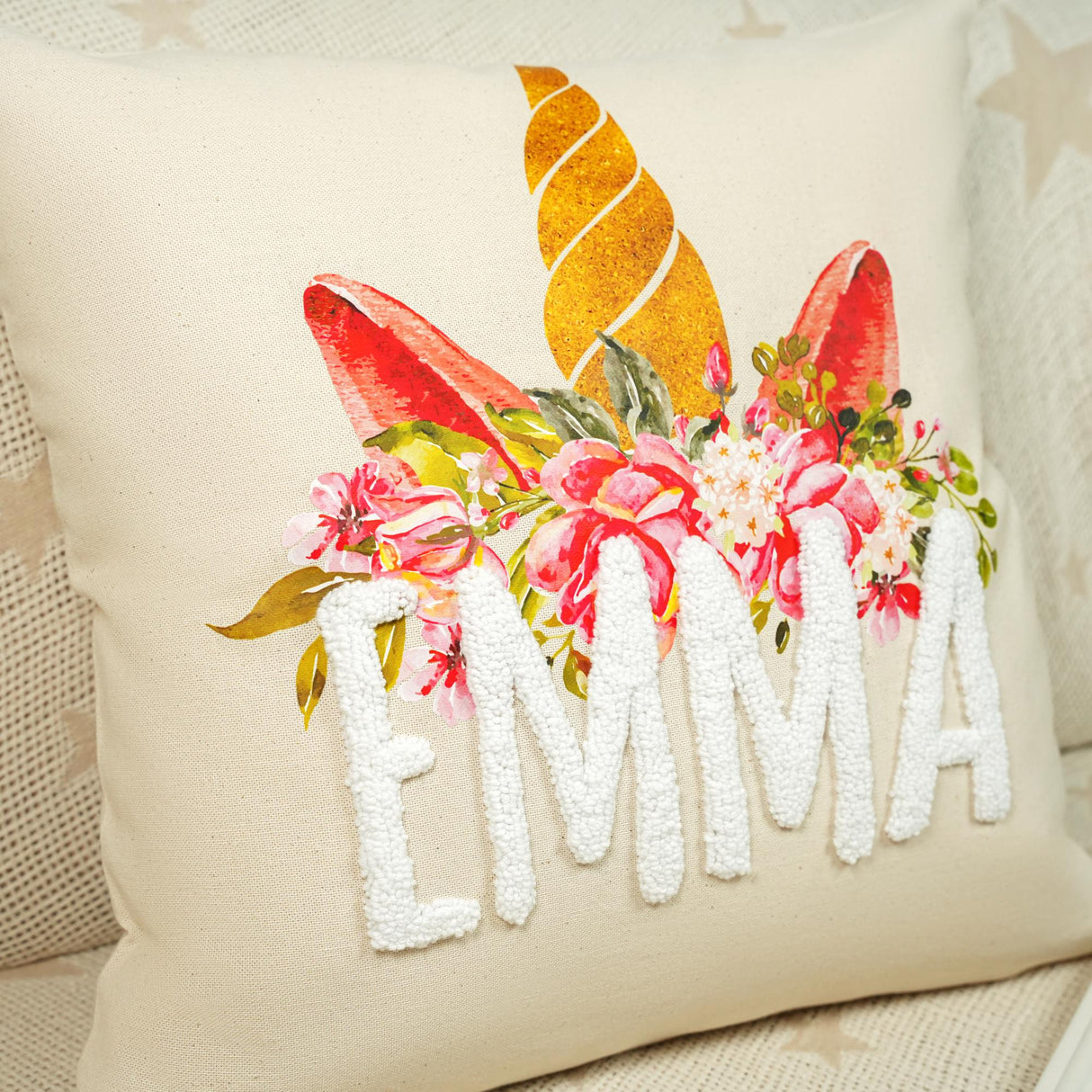 a white pillow with a floral design on it