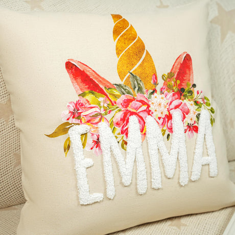 a white pillow with a floral design on it