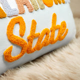 a close up of a pillow with a name on it