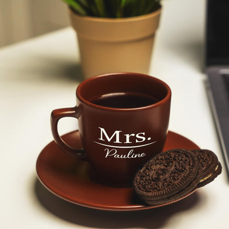 a cup of coffee and a cookie on a saucer