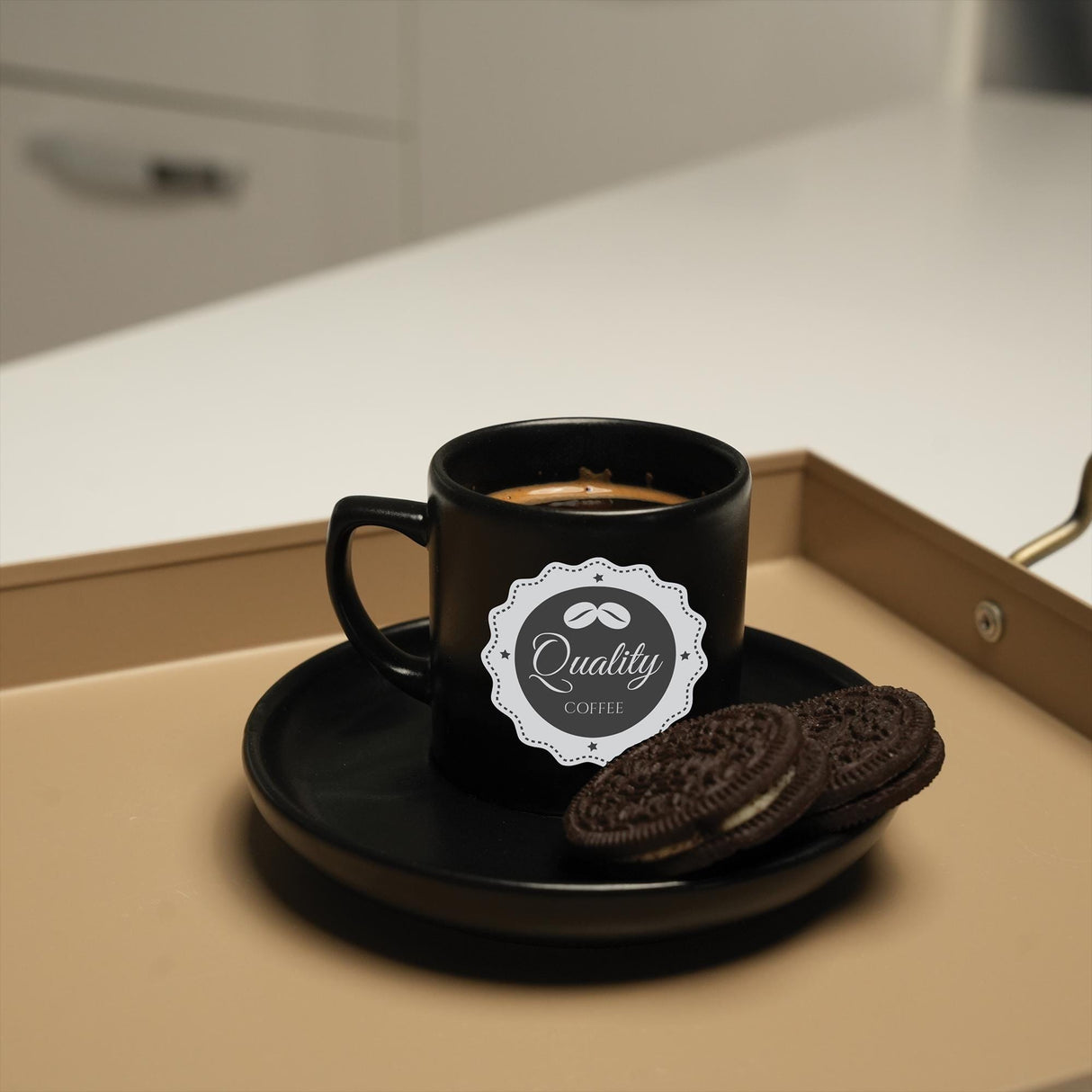 a cup of coffee and a cookie on a tray