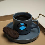 a cookie and a cup of coffee on a tray