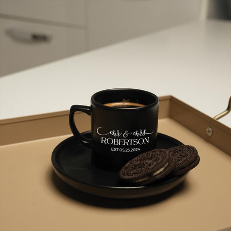 a cup of coffee and a cookie on a tray