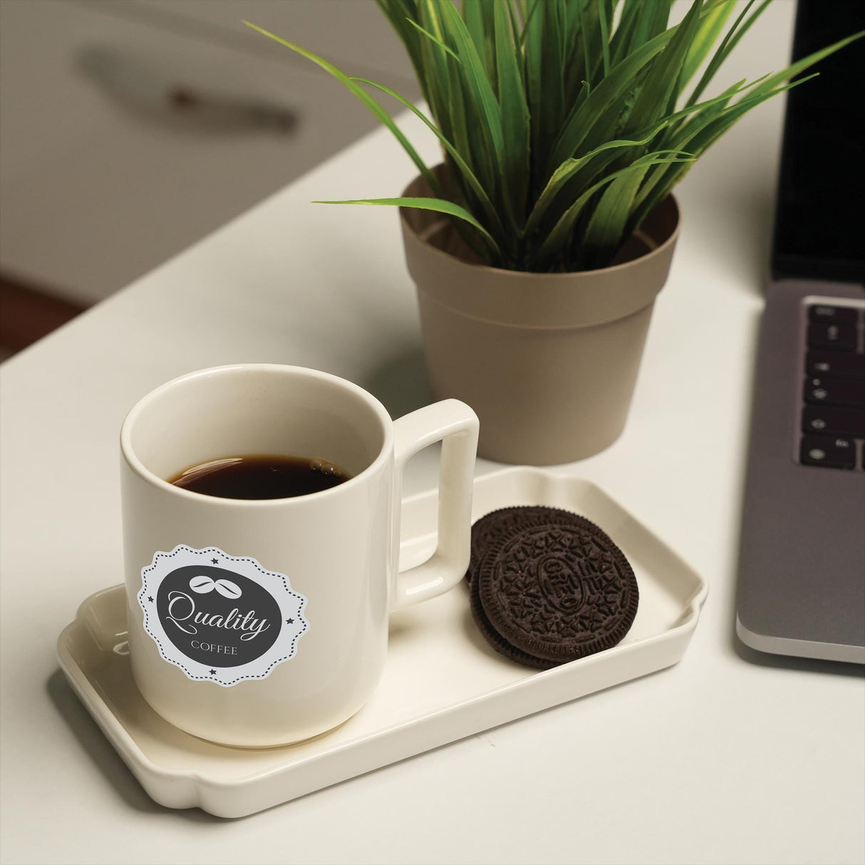 a cup of coffee and a cookie on a tray