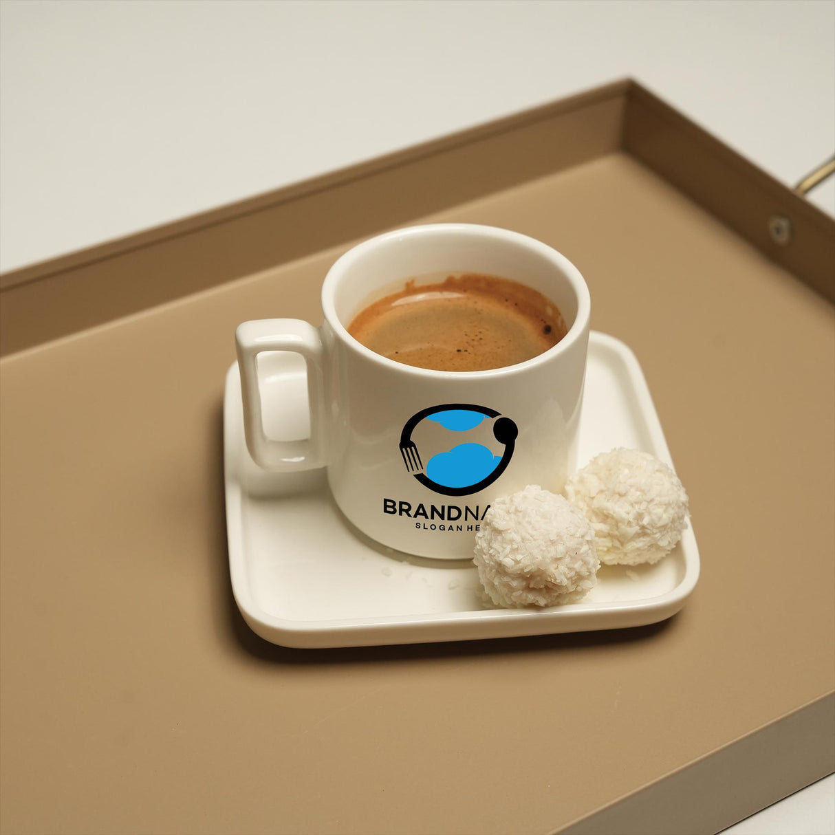 a cup of coffee on a tray with a biscuit