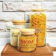 three jars of food sitting on top of a wooden table