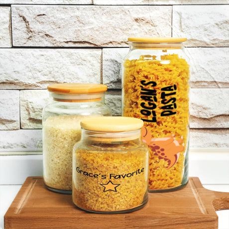 three jars of food sitting on top of a wooden board