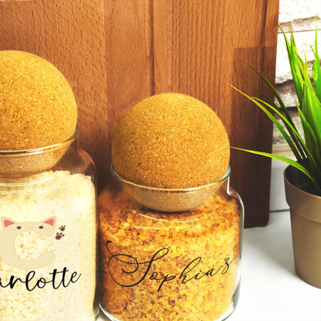 a couple of jars filled with food next to a potted plant