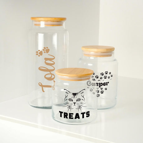 three glass jars with cat images on them